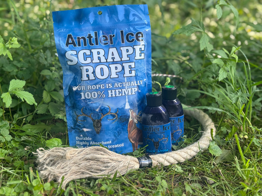 Antler Ice Scrape Rope packaging with two bottles of buck urine and a hemp rope out of the packaging on a grassy background