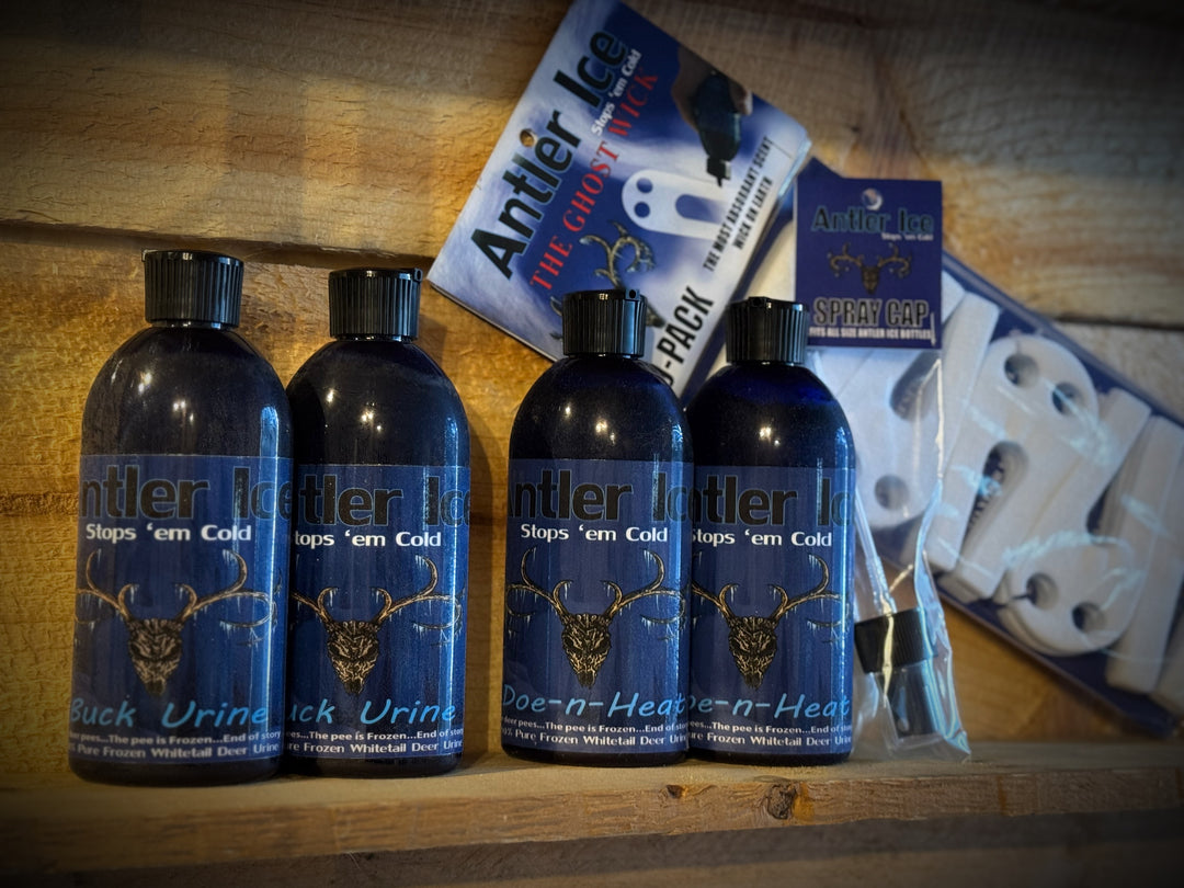 Four bottles of Antler Ice on a wooden surface with packaging in the background.